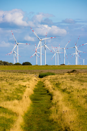 Wind farm with many wind turbines on the horizon