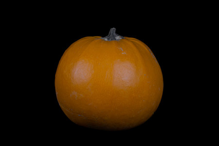Orange pumpkin isolated on black backgroundの写真素材