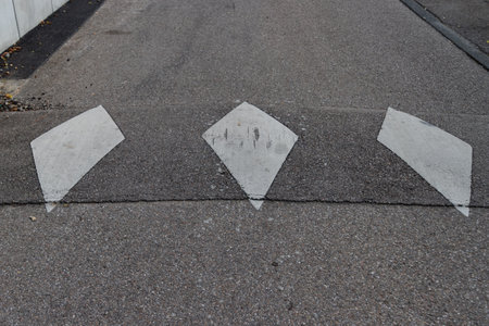 White diamond road marking to signal to reduce speed