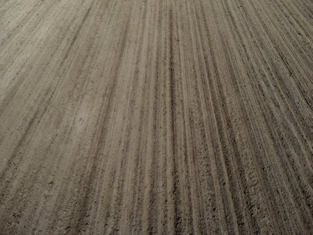 Aerial view of a plowed and cultivated field for backgroundの写真素材