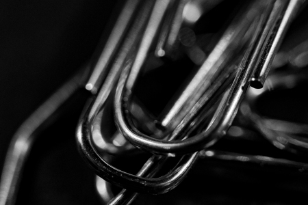 a bunch of paperclips are lying on a black table and shining
