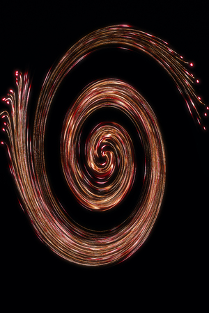 abstract graphic representation of a coloured spiral or nebula, similar to a galaxy on a black background. The conceptual structure consists of different lights and colours and results in a unique pattern and texture.の写真素材