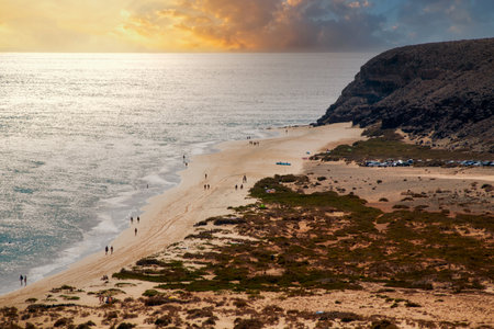 View over a bay on the Canary Islands, on the east coast of Fuerteventura at the yellow orange beautiful evening lightの写真素材