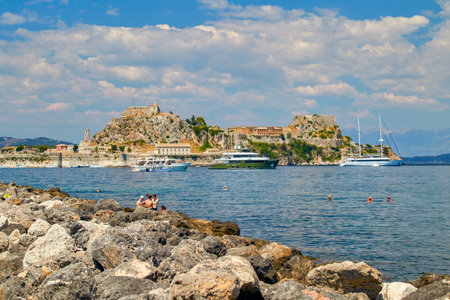 Bathing area with bathers at the surf cliffs at the old port of Kerkyras, Corfu, Greeceのeditorial素材