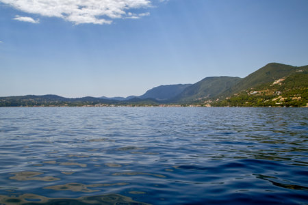 Strait between Corfu and Albania, panoramic view of the east coast of the Greek island under a blue sky with light cloudsの写真素材