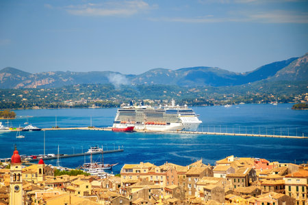 a large cruise ship is moored at the pier of Kerkyra city in front of the historic old townの写真素材