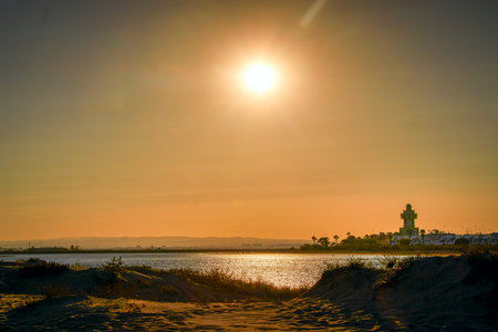 View across the lagoon to the Isla Cristina lighthouse from Playa de la Gaviotas, Andalusia, Spainの写真素材