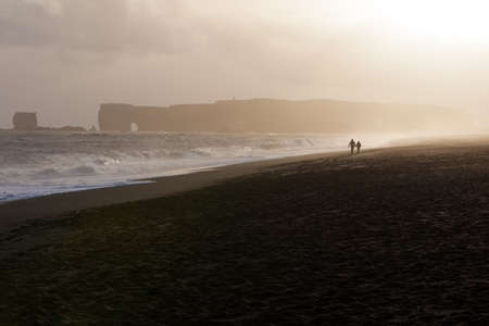loving couple on the coast at sunsetの写真素材