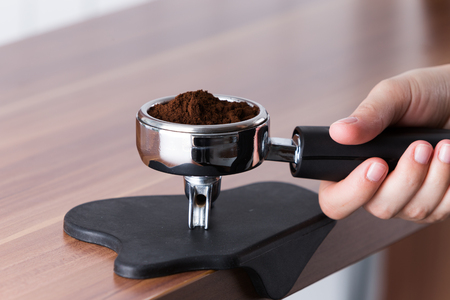ground arabica seeds for espresso in handleの写真素材