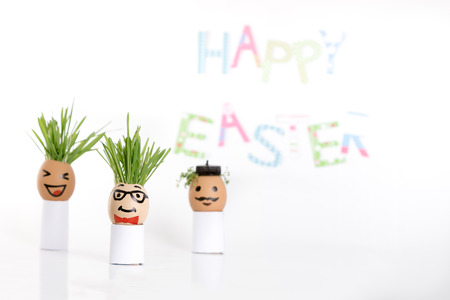 Happy Easter decoration made of  egg-shell faces with hairの写真素材