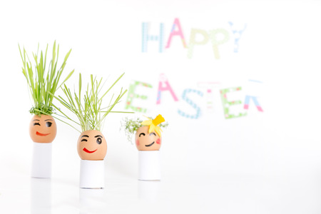 Happy Easter decoration made of  egg-shell faces with hairの写真素材