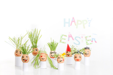 Happy Easter decoration made of  egg-shell faces with hairの写真素材