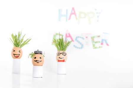 Happy Easter decoration made of  egg-shell faces with hairの写真素材