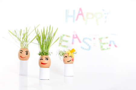 Happy Easter decoration made of  egg-shell faces with hairの写真素材