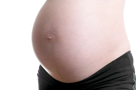 Detail of woman`s pregnancy belly on white background