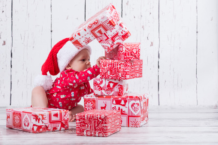 baby in red demolishing the gift towerの写真素材