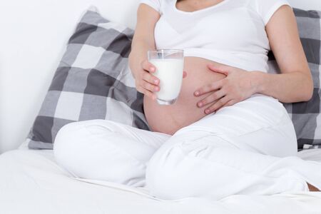detail of drinking glass of milk during pregnancyの写真素材