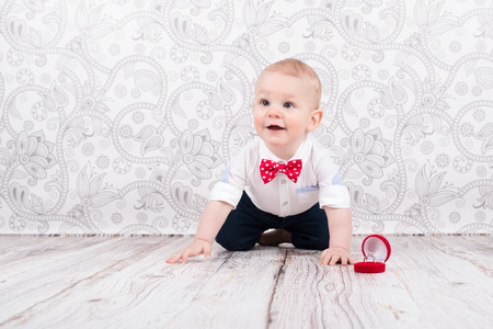 Lovely baby boy smilling and pose with betrothal ringの写真素材