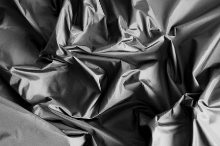 image of a black fabric with a lot of wrinklesの写真素材