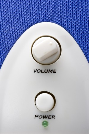 detail of a blue bass speaker with power and volume controlsの写真素材
