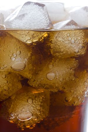 cola soft drink in a glass full of ice cubesの写真素材