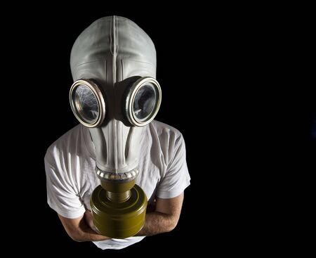 a man wearing a gas mask environment danger concept imageの写真素材