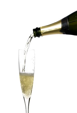filling a glass cup with champagne wine isolated on withe backgroundの写真素材