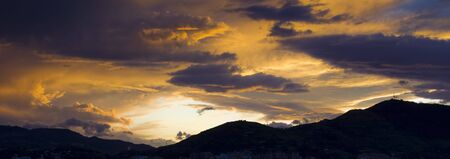 amazing sunset sky over the mountainの写真素材