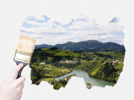 hand holding a painting brush isolated on withe backgroundの写真素材