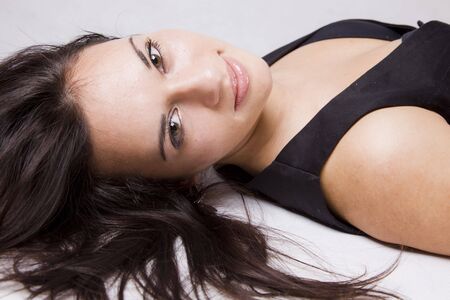 close up of a pretty young girl lying on the floorの写真素材