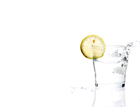 glass of liquid with lemon isolated over a withe backgroundの写真素材