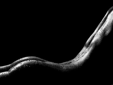 sexy female body shapes and curves over a dark backgroundの写真素材