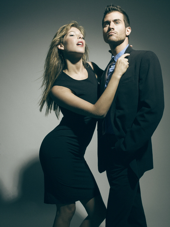 glamour attractive man and woman posing in the studioの写真素材