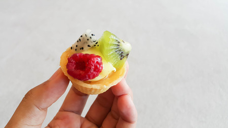 hand holding a mini Fruit Tarts