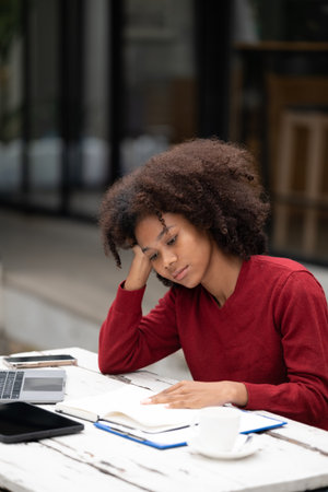 American African Woman working with computer phone and Tablet outdoor.の写真素材