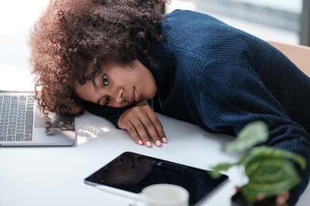 American African Woman working in the office with computer phone and Tablet.の写真素材