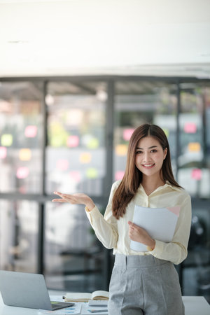 Charming Asian woman with a smile looking to the camera in the office.の写真素材