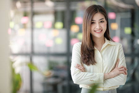 Charming Asian woman with a smile looking to the camera in the office.の写真素材