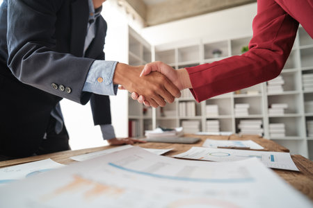 Handshake as successful negotiation ending, close-up. Unknown business people shaking hands after...