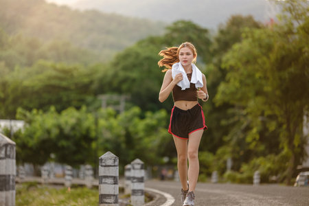 Healthy Asian woman is jogging running outdoor. Sport girl running. Female exercising at outdoor...