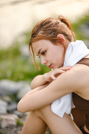 Happy slim woman wearing sportswear in the garden at sunrise. Young beautiful asian female in sports bra running outdoor. Workout exercise in the morning. Healthy and active lifestyle concept.の写真素材