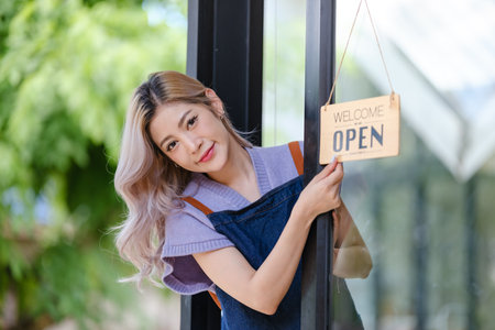 Asian female employees greet customers at a coffee shop.