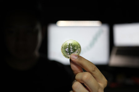 Crypto money bitcoin background. Crypto hacker hand hold golden BTC bit coin. Digital money, stock...