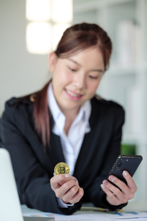 Close Up Business woman look at Bitcoin btc cryptocurrency in finance exchange trade for digital money gold technology cash. Person invest in electronic online payment marketの写真素材