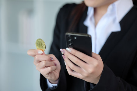 Close Up Business woman look at Bitcoin btc cryptocurrency in finance exchange trade for digital money gold technology cash. Person invest in electronic online payment marketの写真素材