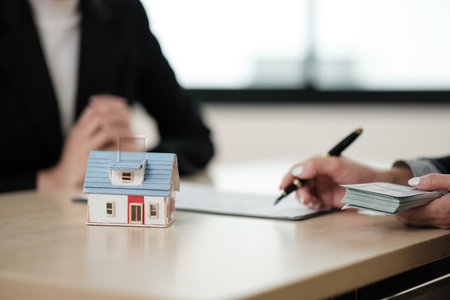 A woman is signing a contract for a houseの写真素材