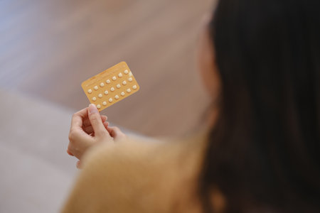 A woman is holding a pill in her handの写真素材