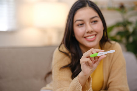 A woman is holding a toothbrush in her hand and smiling