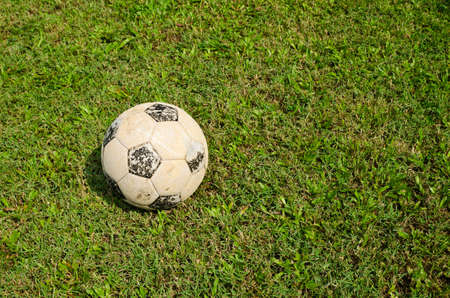 Old football in an old field の写真素材