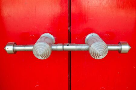Door handle on red old door の写真素材